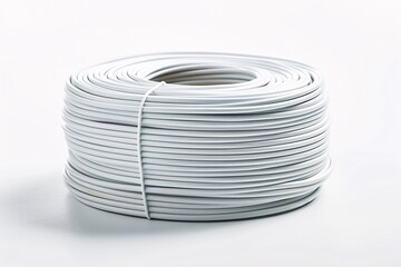 A solitary roll of pale wire on a blank backdrop.