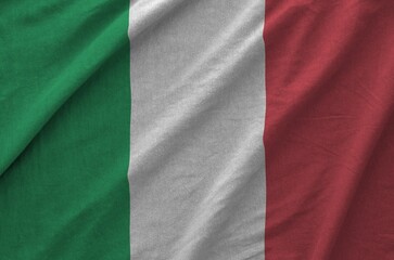 Italy flag depicted on folded wavy fabric of old cloth close up