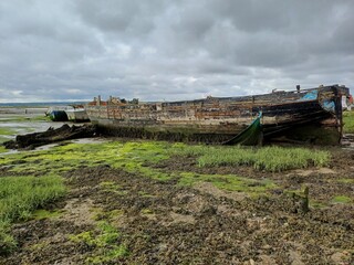 An abandoned boat on the beach