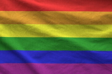 LGBT community flag depicted on folded wavy fabric of old cloth close up