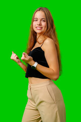 Young Woman Celebrating Success With Raised Fists Against Green Screen Background