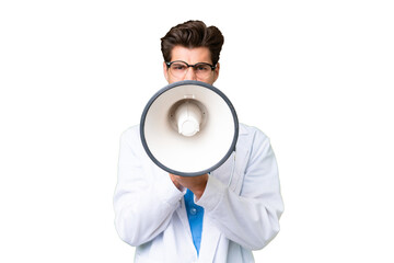 Young doctor man over isolated background shouting through a megaphone