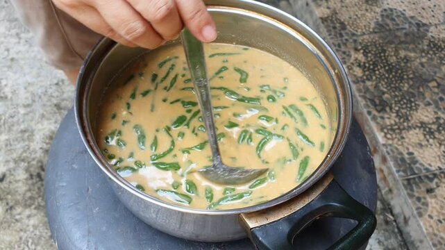 the dawet ice (es cendol) vendor is being prepared the dawet ice. view of cendol being prepared at a road stall. Street food concept. high angle shot, closeup