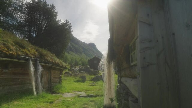 Young couple hiking through lush green valley in Innerdalen Norway on a sunny day