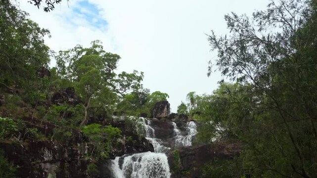 Rainy season Cedar Creek Falls Whitsundays Airlie Beach Proserpine Waterfall slow motion river Australia reserve Palm Grove QLD Queensland spring summer autumn winter sunny blue sky clouds pan