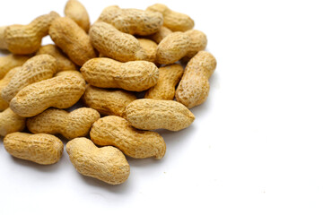 Roasted peanuts in shell on white background.