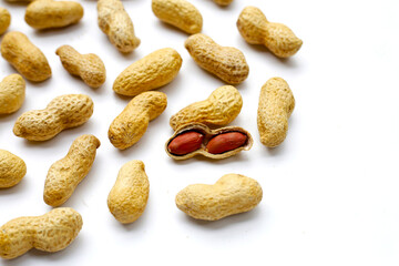 Roasted peanuts in shell on white background.