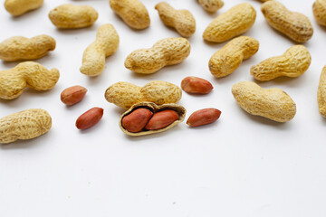 Roasted peanuts in shell on white background.