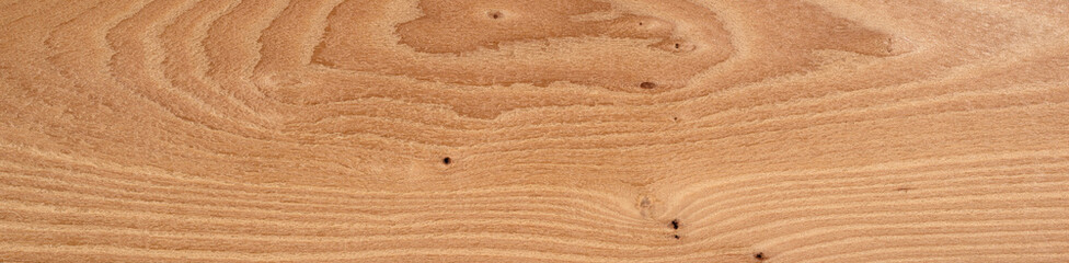 Warm Eibe veneer wood surface showcasing natural whorl patterns and knots