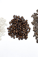 Roasted watermelon, pumpkin, sunflower seeds on white background.