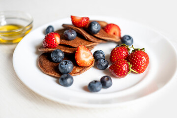 Buckwheat flour pancakes decorated with berries. Gluten free, sugar free. Delicious and healthy breakfast.