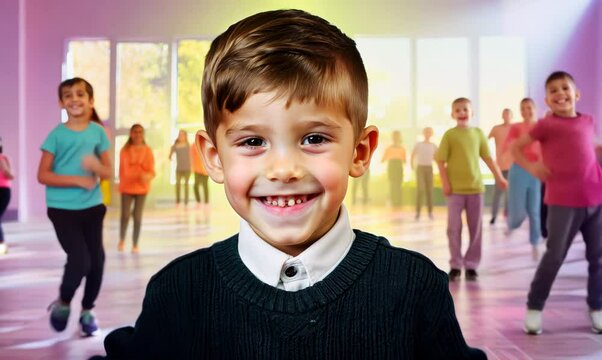 Medium shot portrait video of a grinning child male that is wearing a chic cardigan against an energetic zumba class with participants dancing background