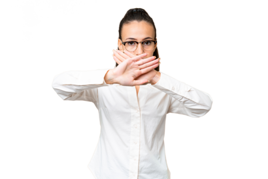 Young Arabian woman over isolated chroma key background making stop gesture with her hand to stop an act