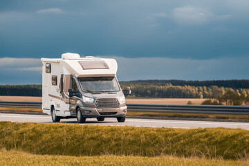 Modern adventure camper or motorhome on the scenic road. Family vacation concept.