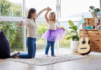 Mother, child and dancing ballet in home, tutu and love in living room or family for fun bonding together. Creative, practice and parent for support in apartment, girl dancer and interest development © CineLens2024/peopleimages.com