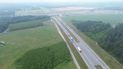 Aerial shot of white truck on empty country road