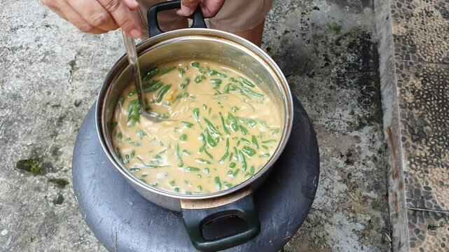 the dawet ice (es cendol) vendor is being prepared the dawet ice. view of cendol being prepared at a road stall. Street food concept. high angle shot, closeup