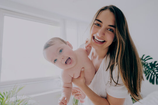 Cheerful mother spending leisure time with son at home