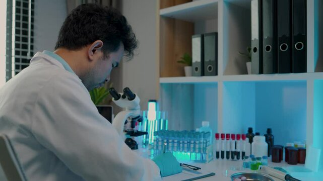 a scientist is working in the laboratory and using microscope, a chemistry is very concentration on his work, science is always in our dairy life, wearing gloves while work in the lab