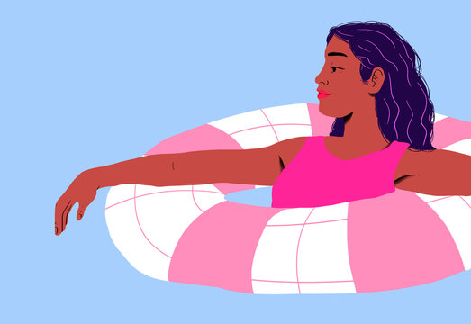 Woman wearing swimsuit floating in pool float