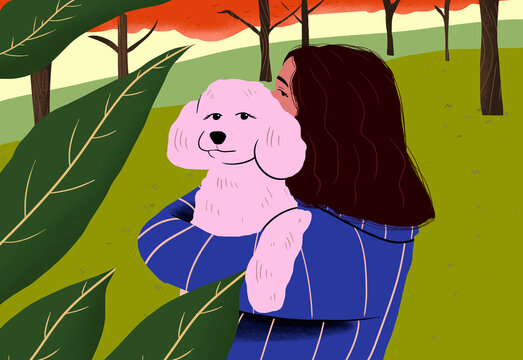 Girl carrying dog against and standing at park
