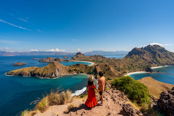 Young couple tourist enjoying the beautiful landscape at Padar island in Komodo National Park, Indonesia