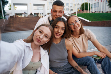 Making selfie. Group of students are outside together
