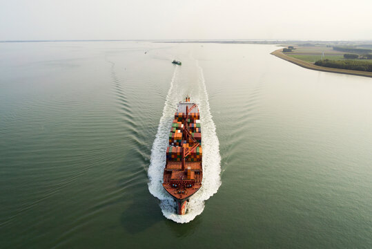 Drone view of container ship on river at Western Scheldt in Netherlands