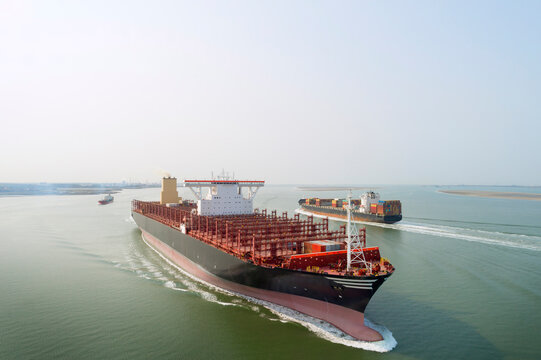 Container ships with cargos on river at Western Scheldt in Netherlands