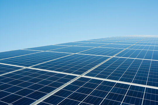 Blue solar panel at power station under clear sky on sunny day