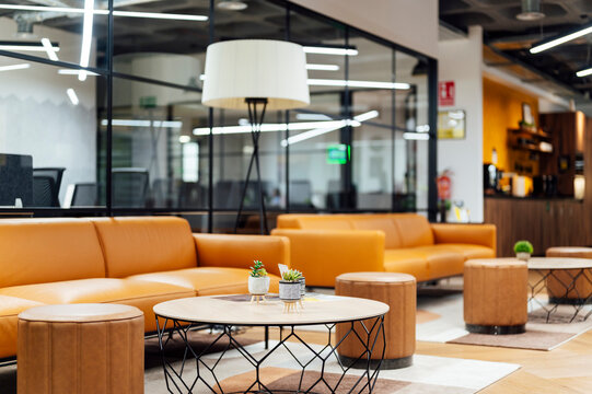 Coffee tables and sofas in illuminated office