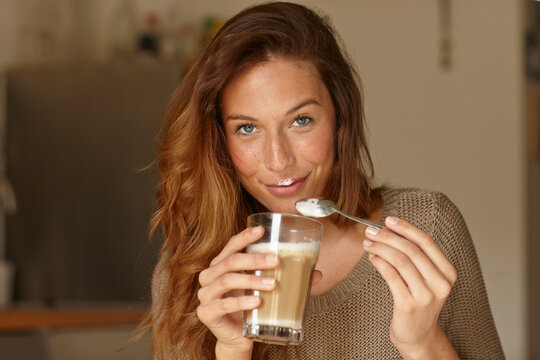 Young woman having coffee at home