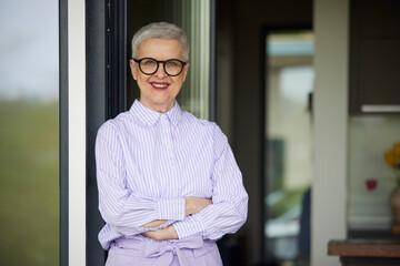 Portrait of confident senior woman at home