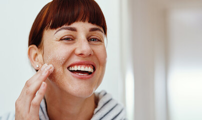 Portrait, skincare and happy woman with salt scrub on face for beauty and exfoliation. Facial, spa...