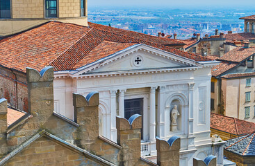 Bergamo Cathedral roof behind the battlements of Palazzo della Ragione, Italy
