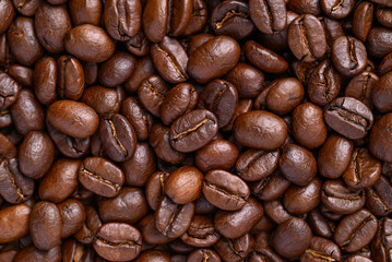Dark roasted Arabica coffee beans texture background
