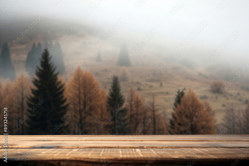 Aufkleber empty wooden tabletop with a blurred autumn forest and misty mountains as background
