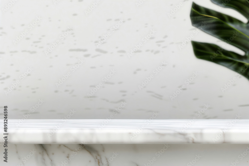 Poster Empty white marble shelf for displaying products with a tropical leaf on a white background