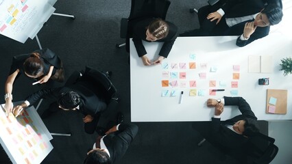 Top view of smart business team planning marketing strategy at meeting room. Professional executive manager exchange data and brainstorm idea while writing in sticky notes at workplace. Directorate.