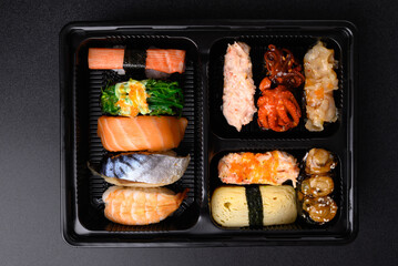 Nigiri sushi and Gunkan maki sushi set in lunch box, Japanese food, Top view © nungning20