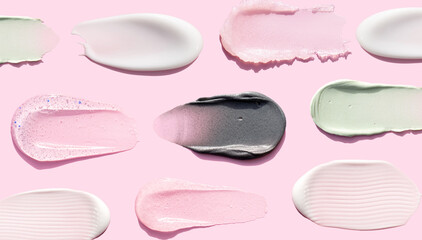 creamy texture of cosmetic samples on pink background
