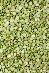 Uncooked, split, green peas background. Dry peas grains. Top view