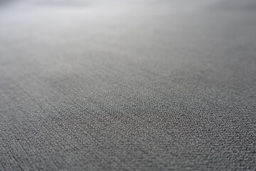 Macro of light gray polyester fabric with herringbone pattern