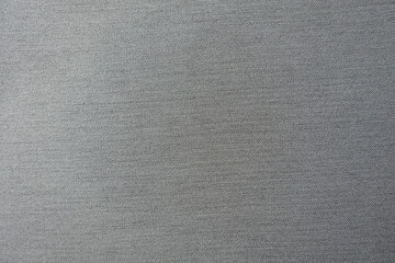 Surface of light gray polyester fabric with herringbone pattern