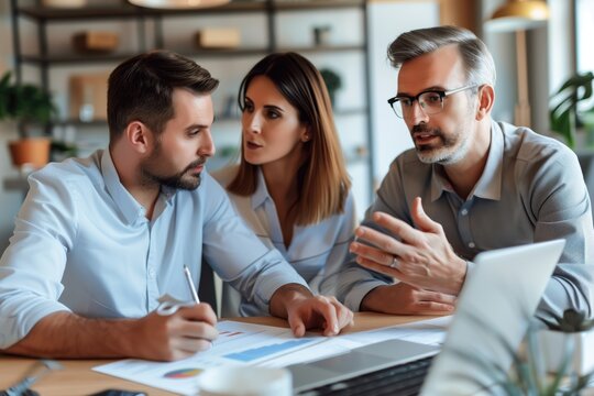 Collaborative meeting with three business professionals discussing financial reports at office. Business strategy planning, teamwork, financial analysis, corporate decision-making, project management.