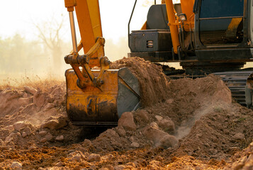 Backhoe working by digging soil at construction site. Crawler excavator digging on demolition site....
