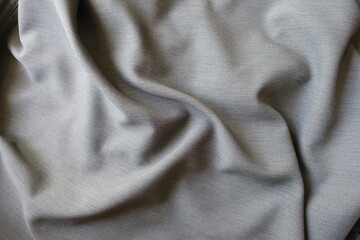 gray polyester fabric with herringbone pattern in soft folds