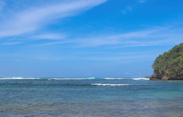 Naklejka premium Beautiful sea view with blue sky and white clouds. Deep blue sea is very clear with small waves at Balaikambang beach malang Indonesia