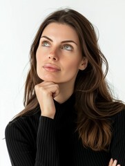 Fototapeta premium An intimate portrait of a brunette woman with piercing green eyes, her thoughtful expression inviting contemplation. Her subtle hand gesture adds to her enigmatic allure.