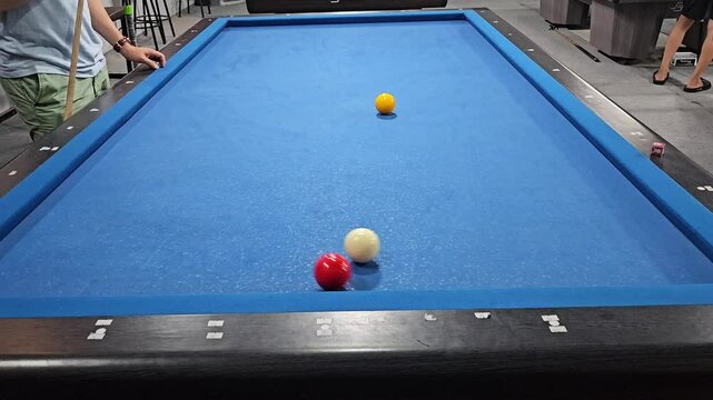 People playing carom 3 cushion billiard games, known as French billiards, it consists of three balls and a table without holes.